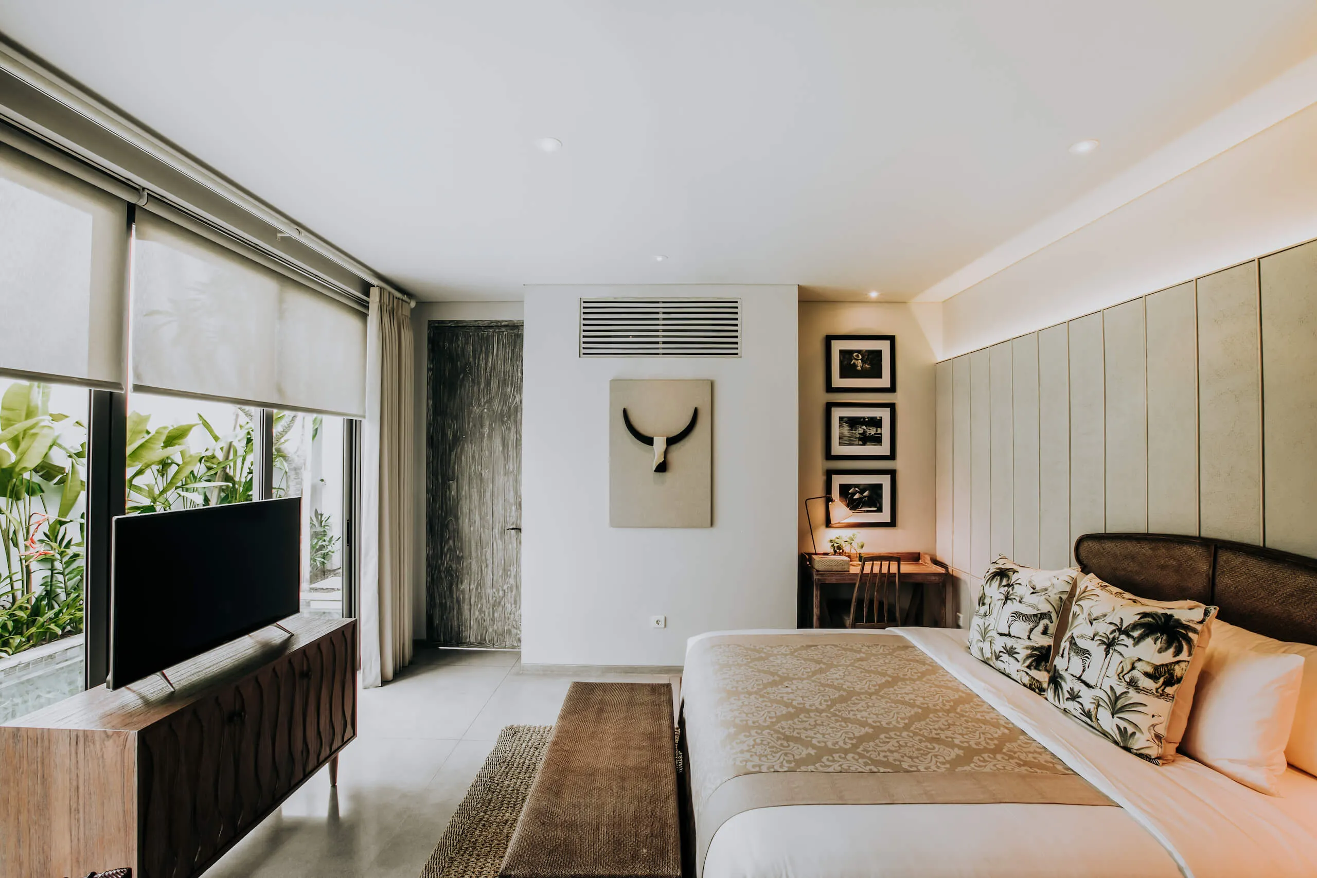 Villa bedroom with artwork and garden windows