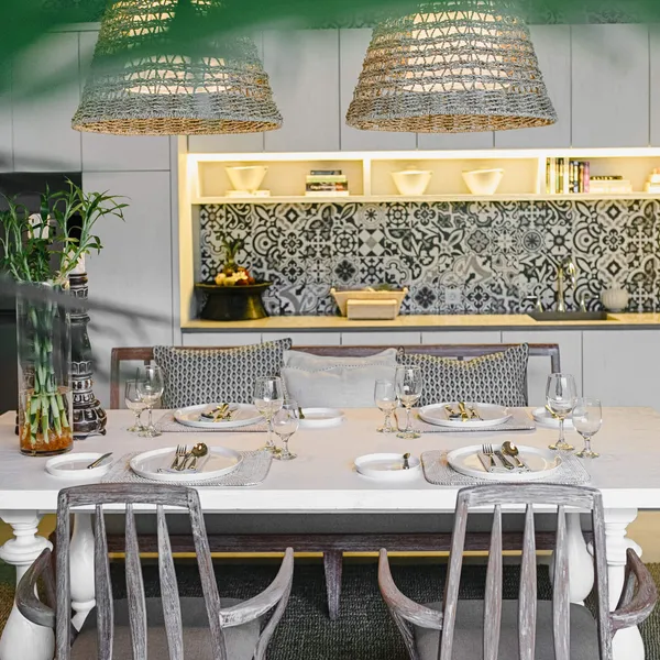 Dining table set in front of the patterned-tile kitchen