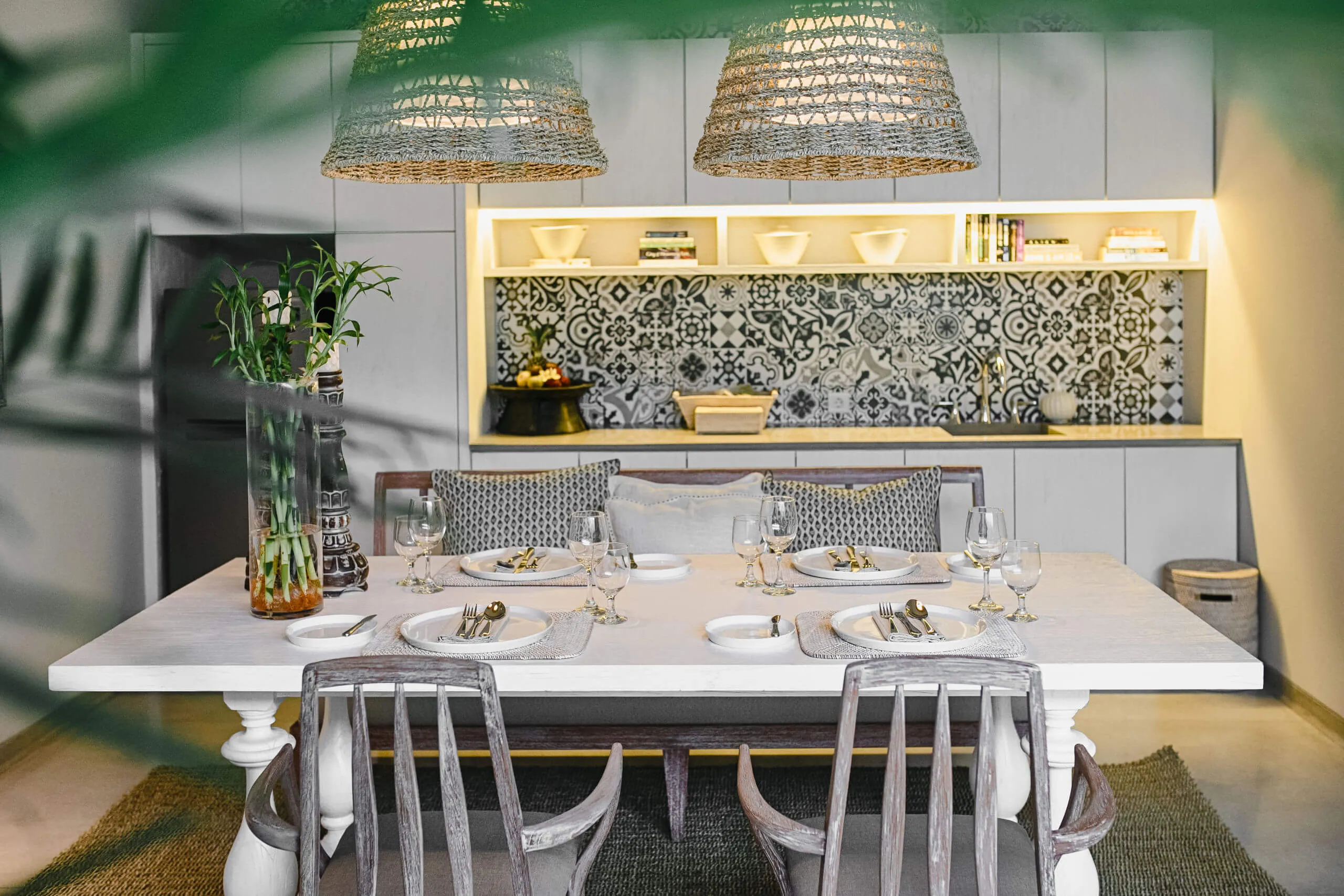 Dining table set in front of the patterned-tile kitchen